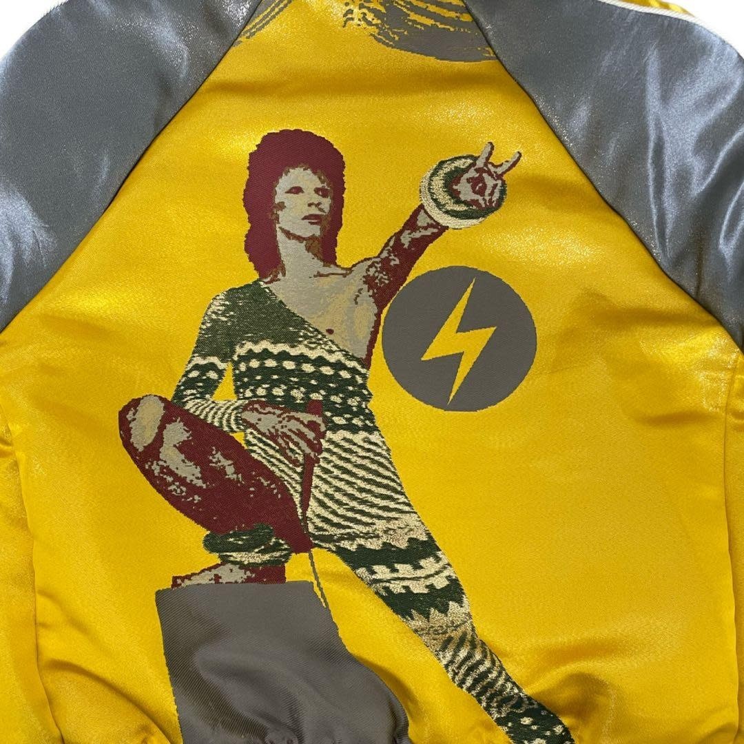 Tasoni yellow satin bomber jacket with David Bowie graphic print and grey accents.