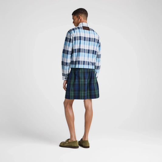 Model wearing Tasoni JW Anderson green and blue plaid check shorts with an elastic waistband from the back view.