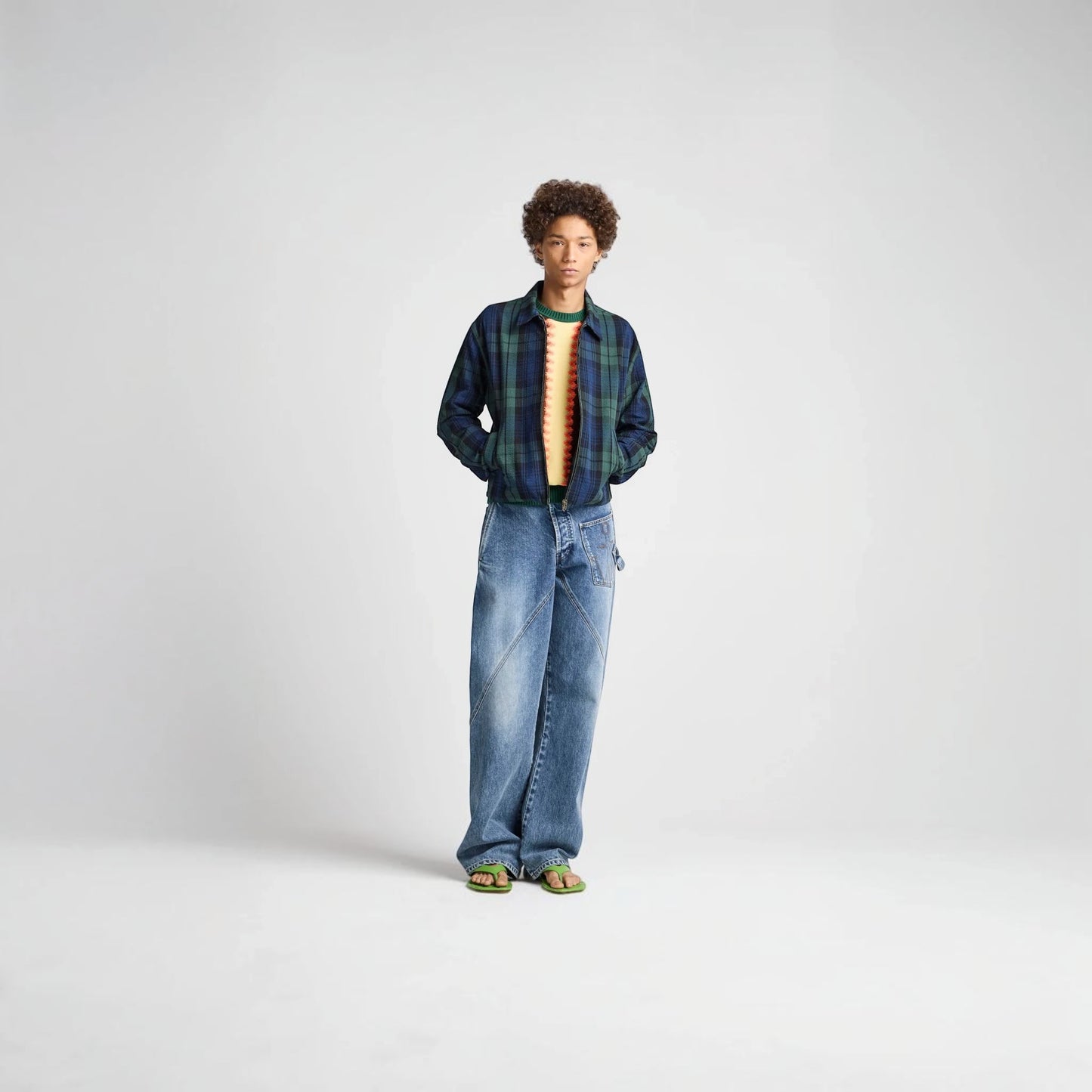 Model wearing a Tasoni J.W.Anderson navy and green cotton check print zip-up jacket with a collared neckline.