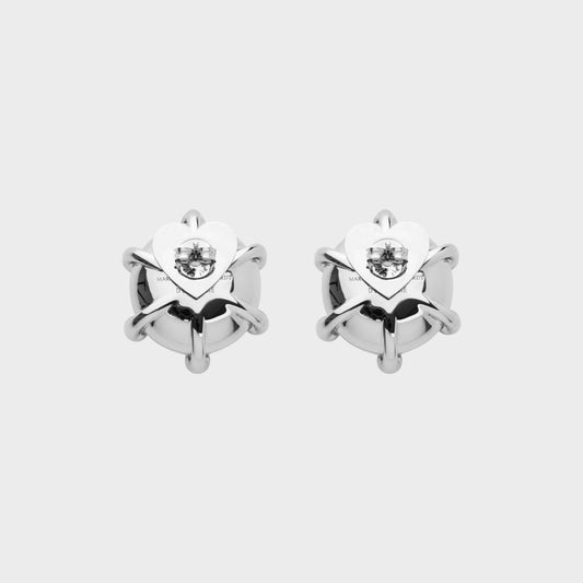 Tasoni Marie Adam-Leenaerdt brass stud earrings with pink crystal accents and heart-shaped backing.