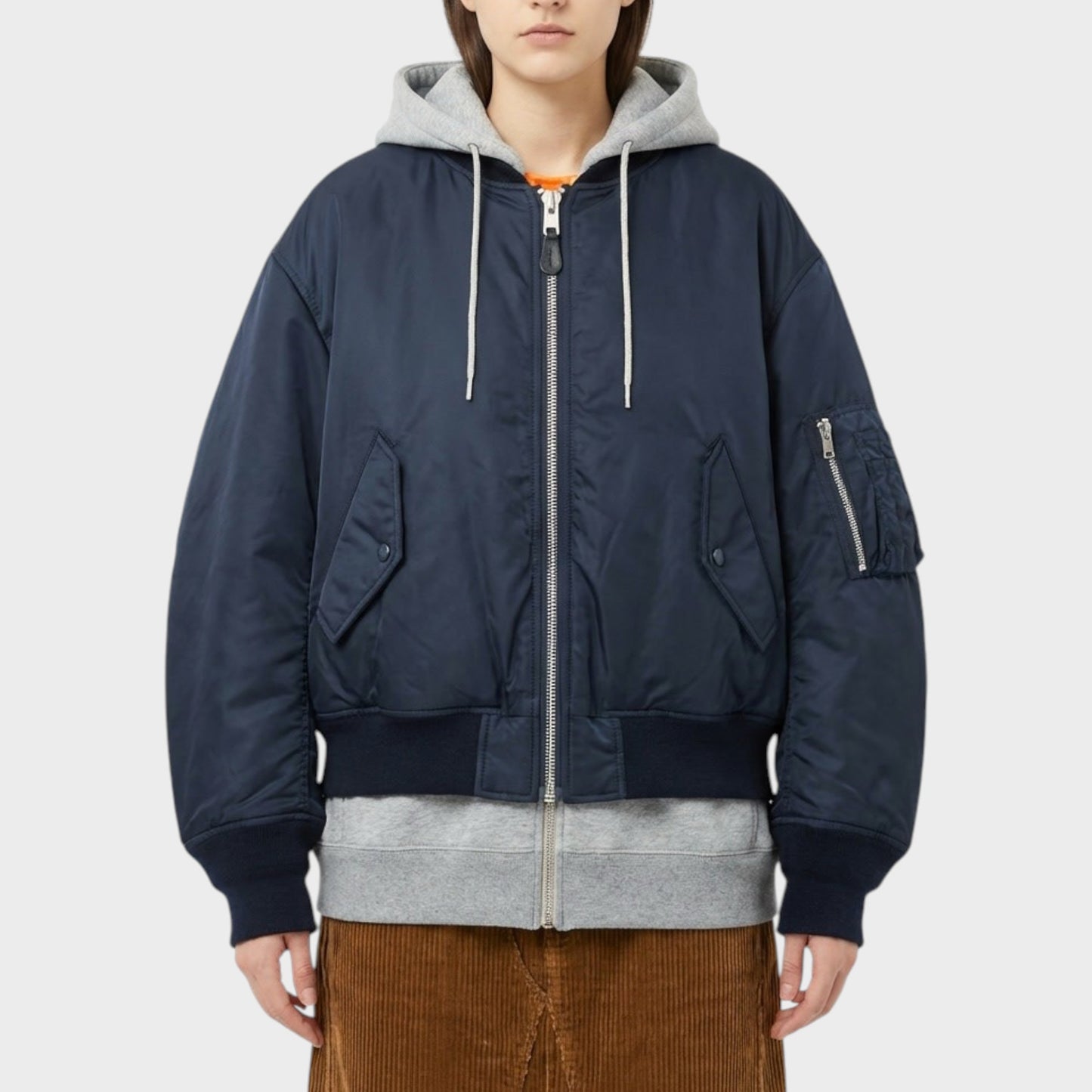 Tasoni navy blue layered hybrid bomber coat with grey hood and orange trim. Features zip closure, utility pocket, and ribbed cuffs.