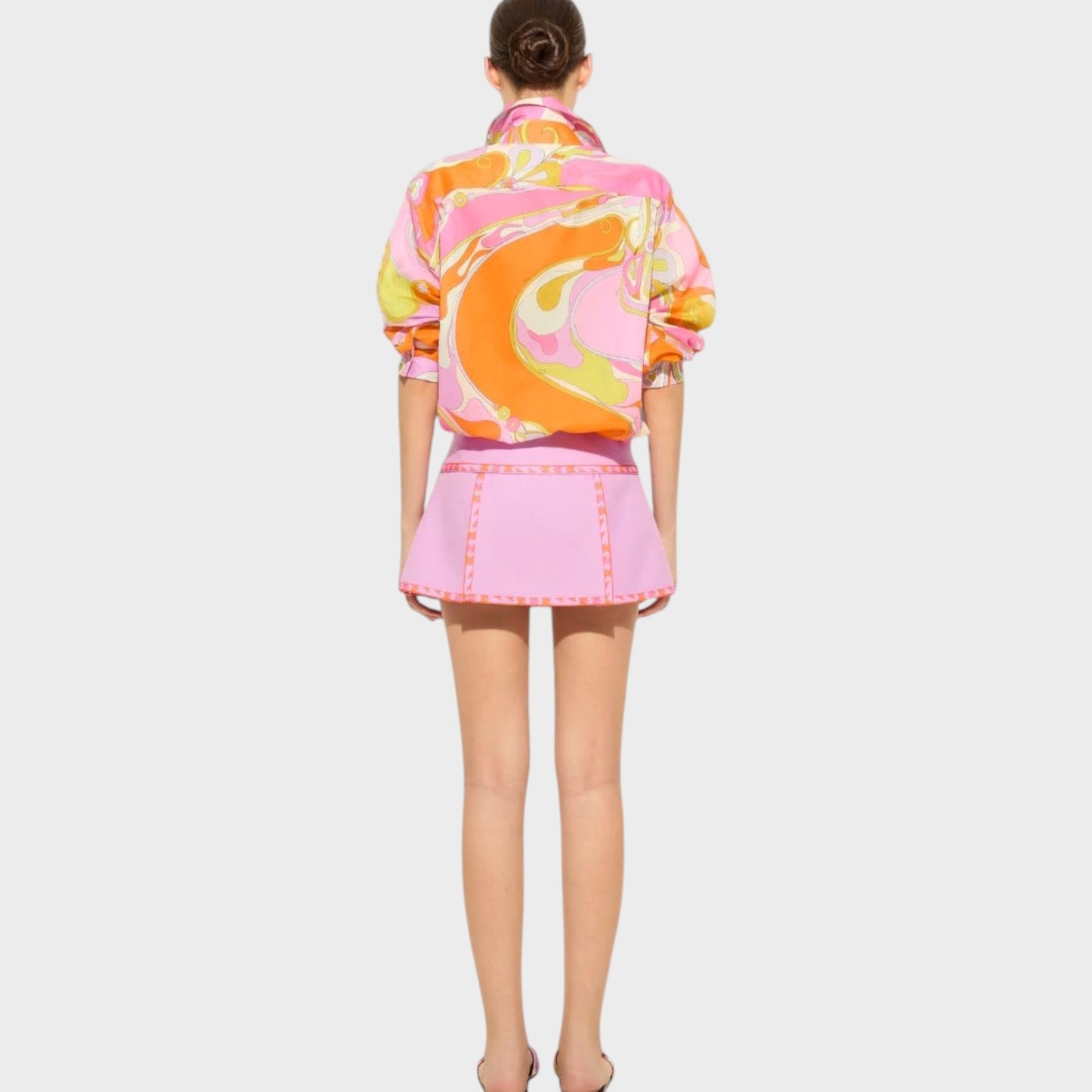 Tasoni Pucci cotton classic shirt featuring a vibrant multicolor Orchidee print, worn with a matching pink mini skirt.