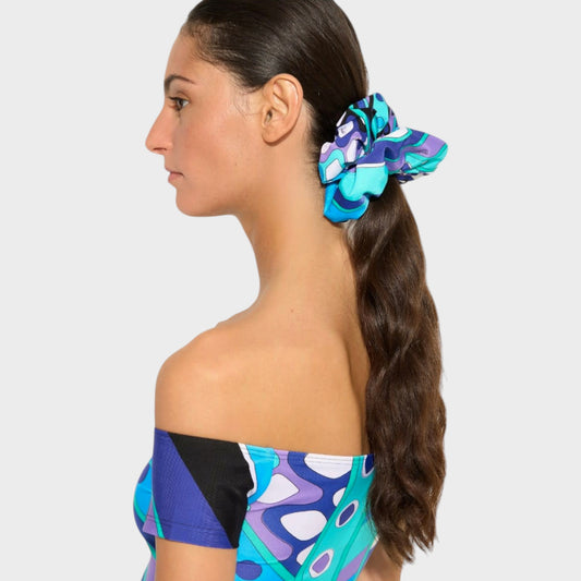Model wearing a Tasoni Pucci zipped scrunchie in turquoise blue with a signature Vivara print in a ponytail.