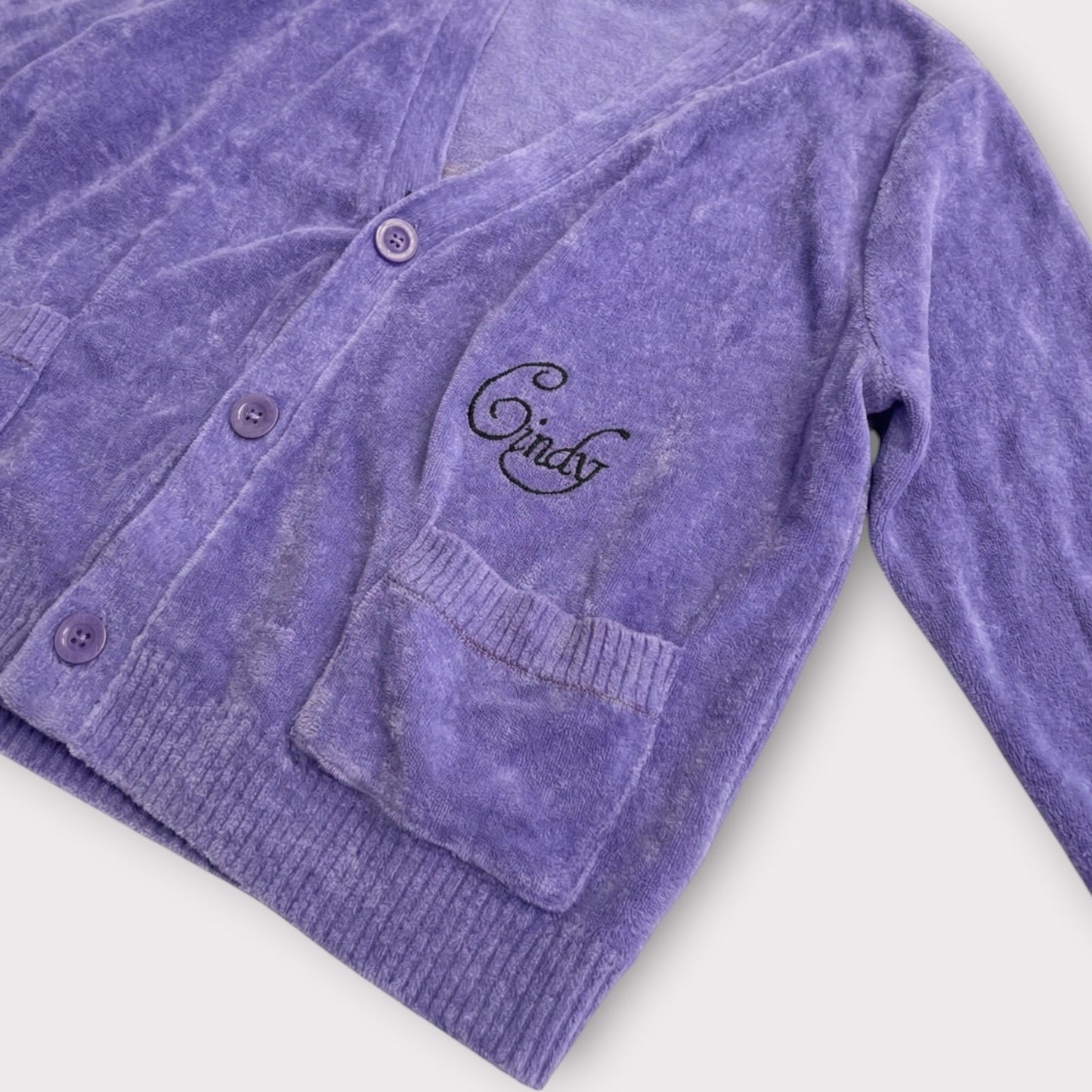 Tasoni purple velour V-neck cardigan with button closure and embroidered 'Cindy' detail on the chest.