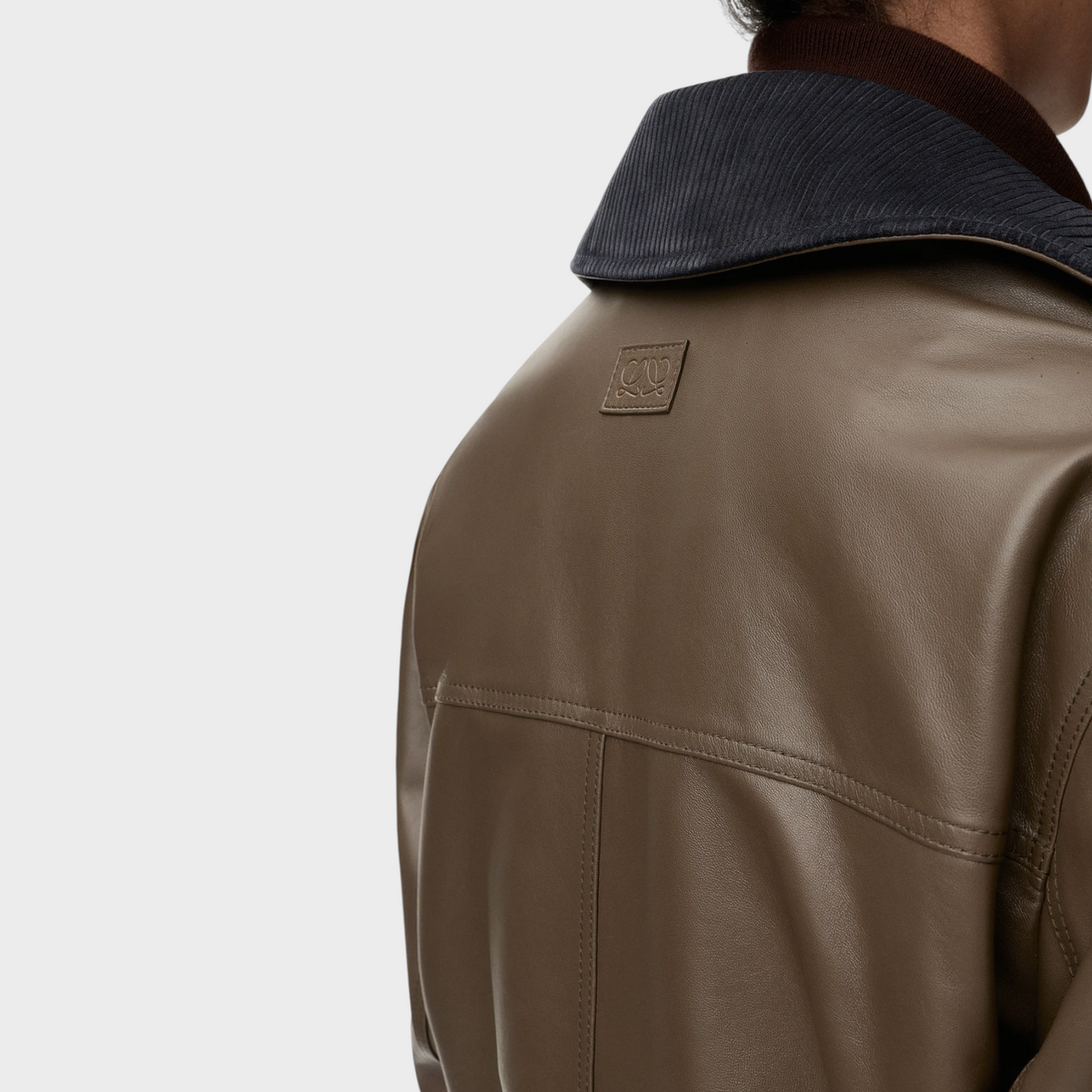 Tasoni Loewe khaki nappa leather short parka featuring a ribbed collar and embossed logo patch on the back.