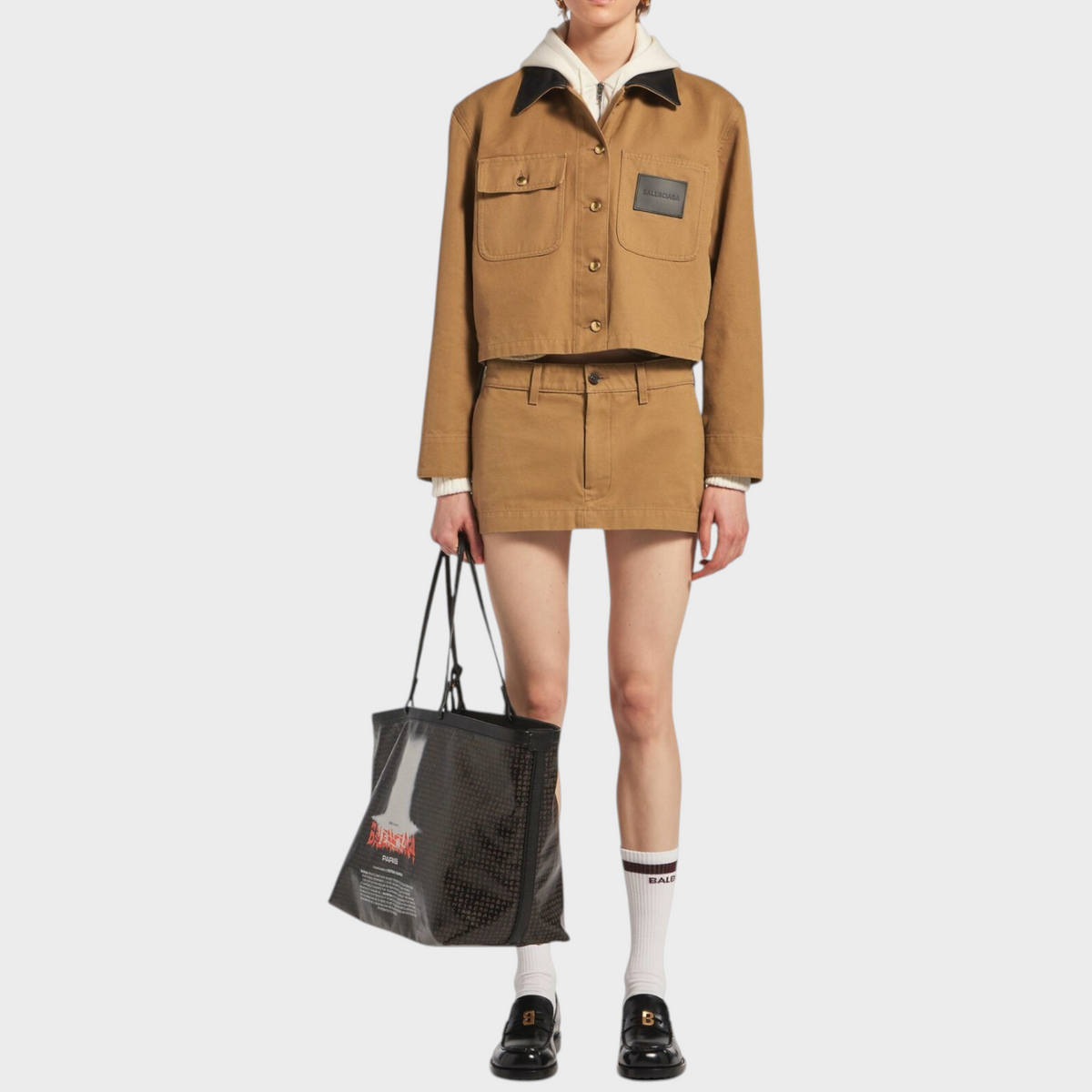 Tasoni Balenciaga cropped tan workwear jacket with a black collar and logo patch worn with a matching mini skirt