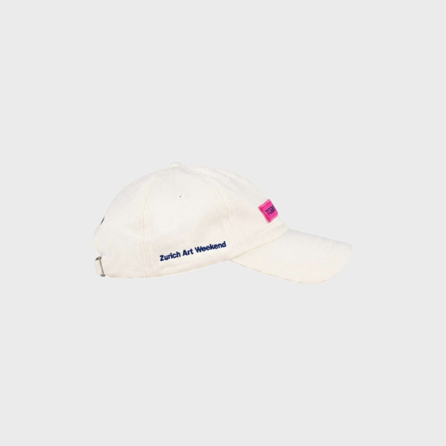 Tasoni x Jan Vorisek white cotton baseball cap with pink logo patch and blue "Zurich Art Weekend" embroidery.