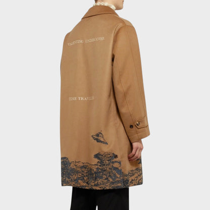 Tasoni beige cashmere coat with "VALENTINO UNDERCOVER" and "TIME TRAVELS" text, featuring UFO embroidery and landscape print.
