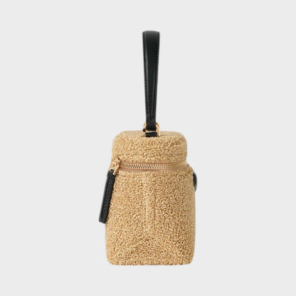 Tasoni beige fuzzy Antigona bag with black leather trim and handle.