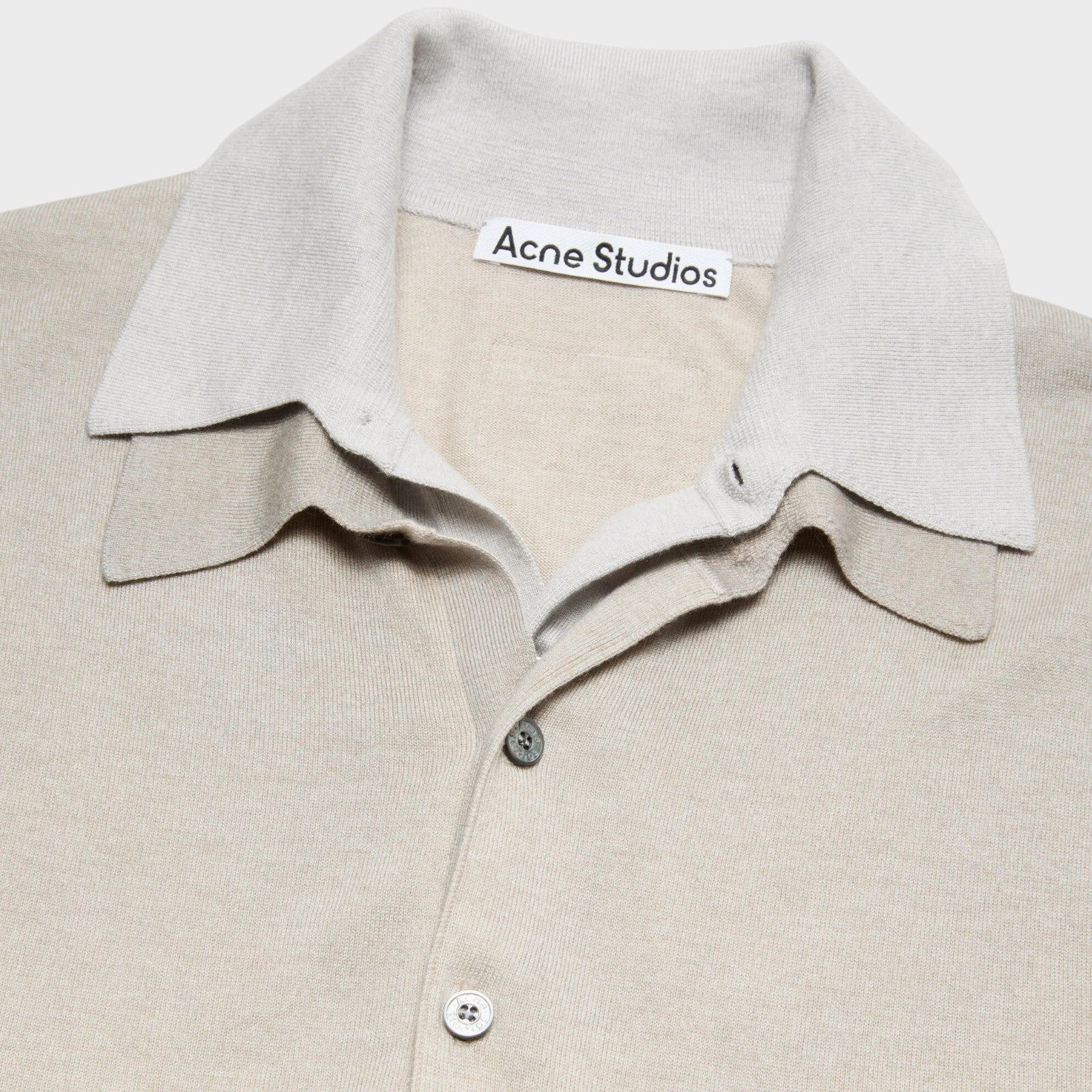 Tasoni Acne Studios beige and grey layered knit sweater with a V-neck and button closure.