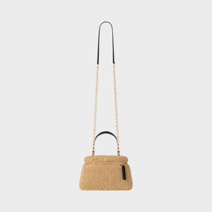 Tasoni beige teddy fabric Antigona bag with gold chain strap and black leather top handle.