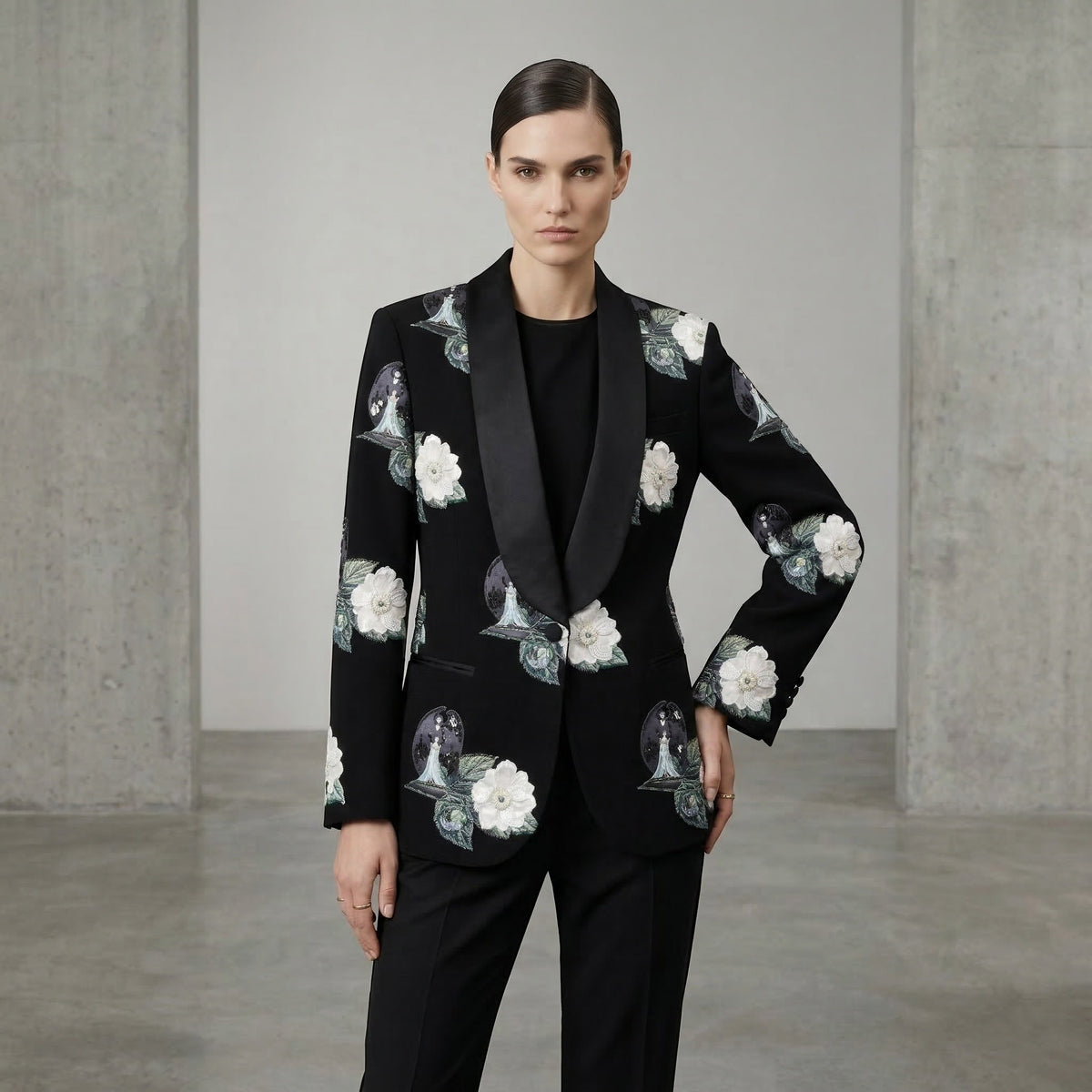 Tasoni black single-breasted blazer with embroidered white floral patches and shawl lapels, worn by a model.