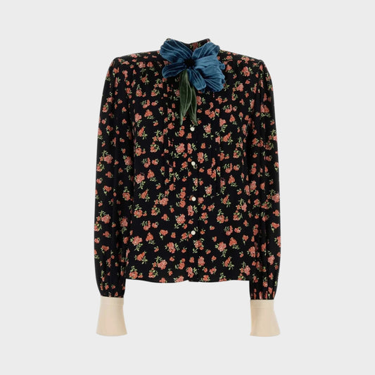 Tasoni black long-sleeve shirt with multicolor floral print and a large teal velvet flower accent at the collar.