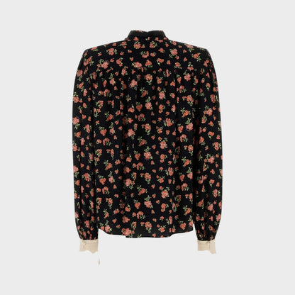 Tasoni black long-sleeve shirt with multicolor floral print and cream cuffs.