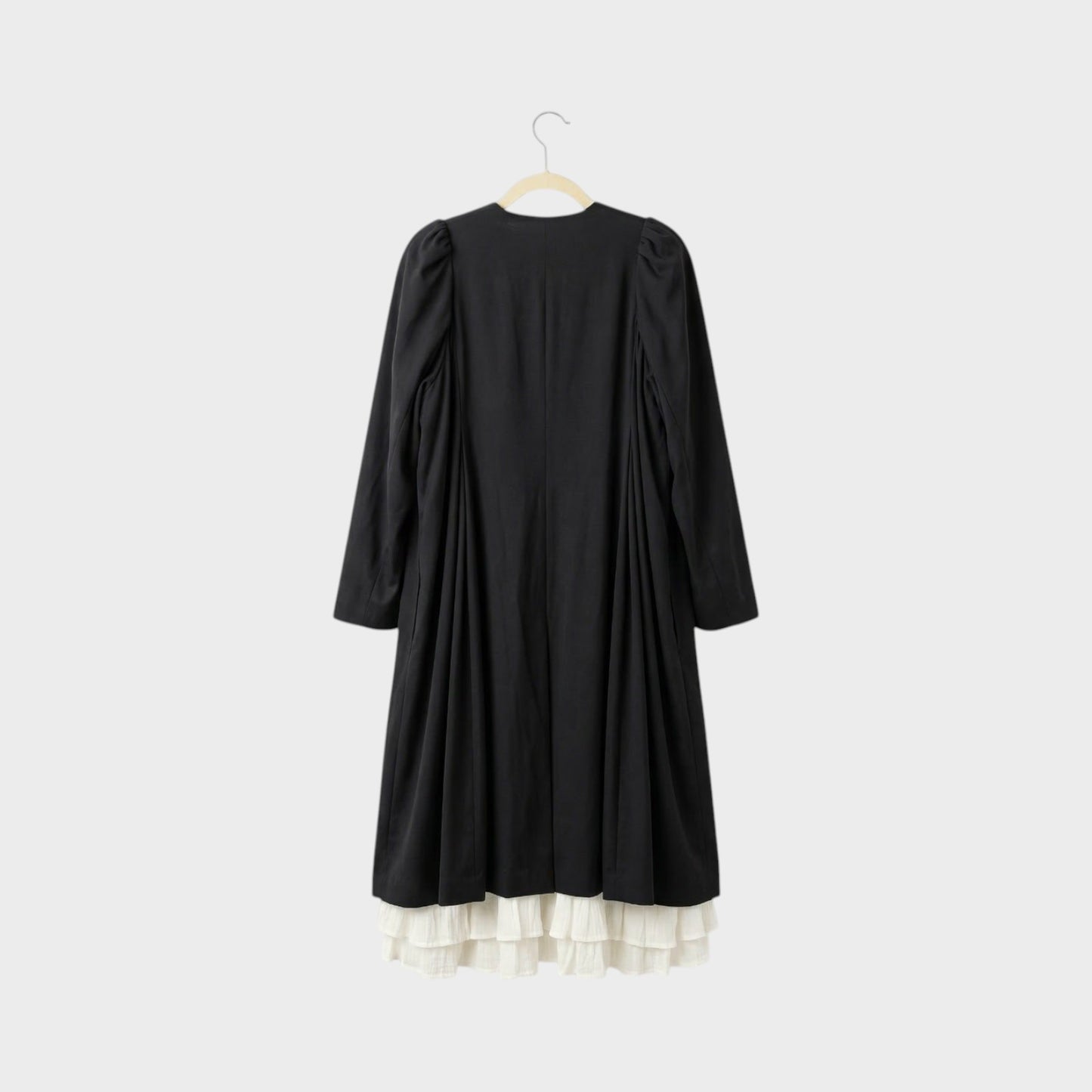 Tasoni black long coat with white ruffled lining and puff sleeves, back view.