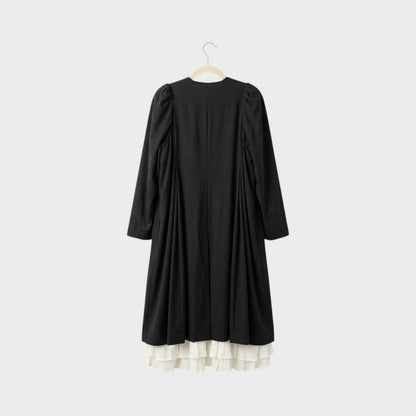 Tasoni black long coat with white ruffled lining and puff sleeves, back view.