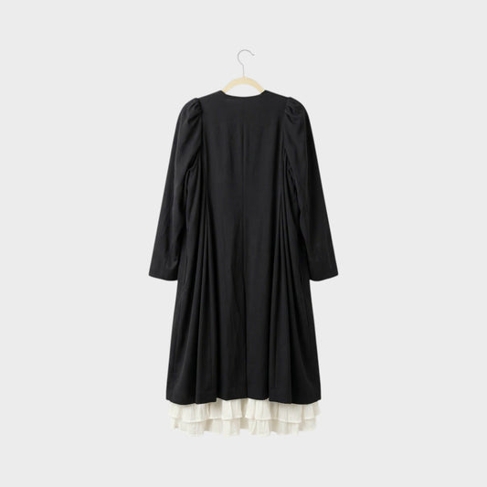 Tasoni black long coat with white ruffled lining and puff sleeves, back view.