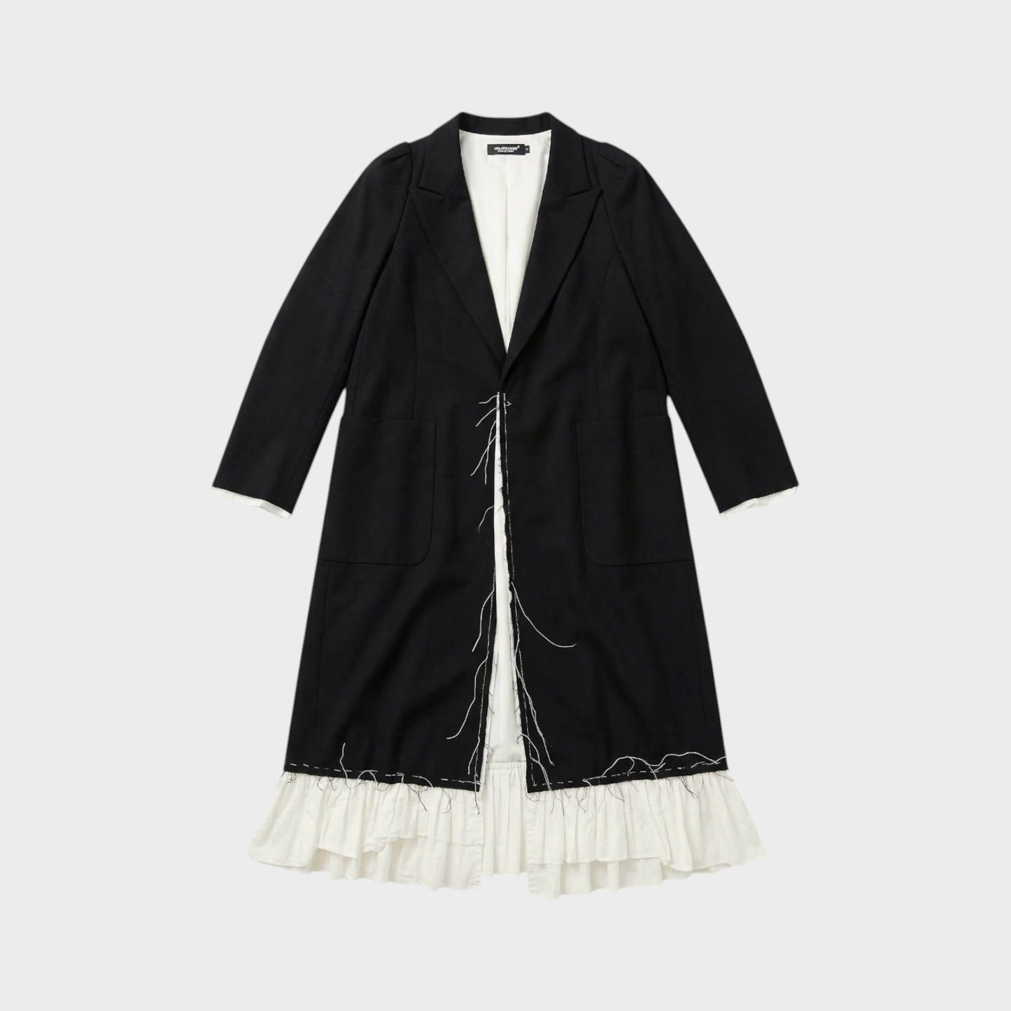 Tasoni black long coat with white ruffled lining and raw edge detail. Features a classic lapel and two front pockets.