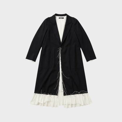 Tasoni black long coat with white ruffled lining and raw edge detail. Features a classic lapel and two front pockets.