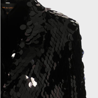 Tasoni black sequin asymmetric coat with velvet trim and a structured shoulder.