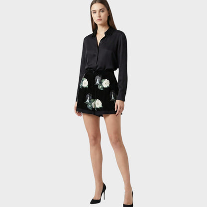 Tasoni black velvet shorts with embroidered white roses and high-waisted front pleats.