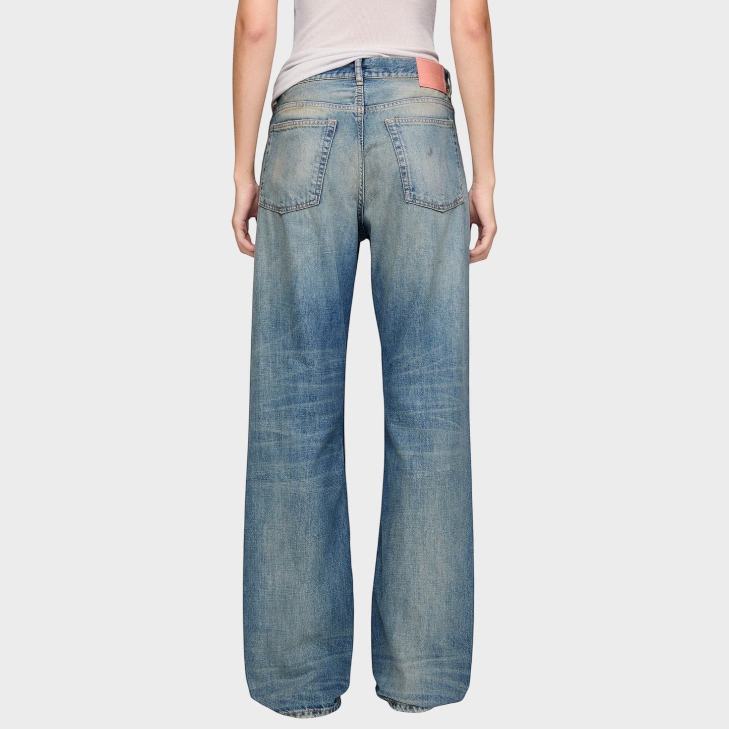 Tasoni mid blue cotton mid waist flare leg denim jeans with distressed detailing and pink logo patch.