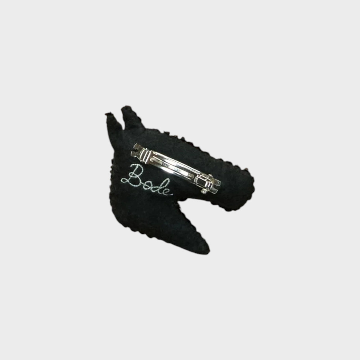 Tasoni Bode black felt hair barrette featuring a hand-applied sequin pony motif and a secure metal clasp closure.