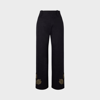 Tasoni Bode high-waisted black trousers with straight legs and gold embroidered floral detail on the cuffs.