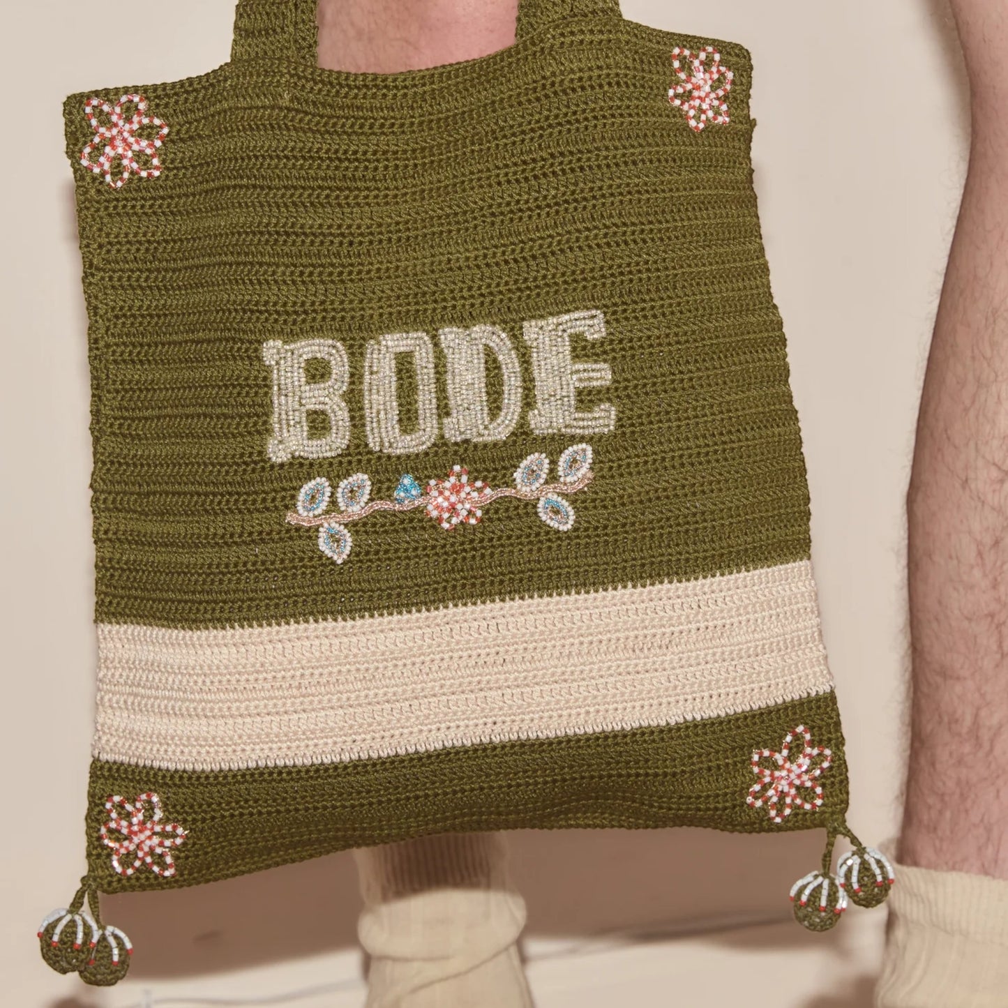 Tasoni Bode Marsh crochet tote bag in green yarn with beaded floral details and "BODE" lettering.