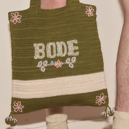 Tasoni Bode Marsh crochet tote bag in green yarn with beaded floral details and "BODE" lettering.
