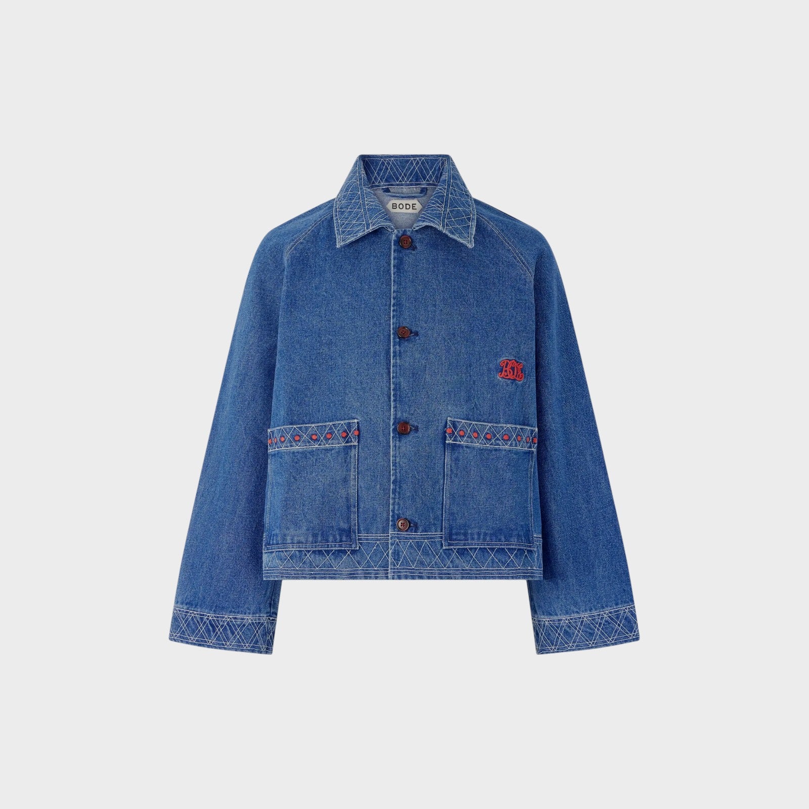 Tasoni Bode embroidered denim jacket in indigo blue with geometric pattern and red accents.