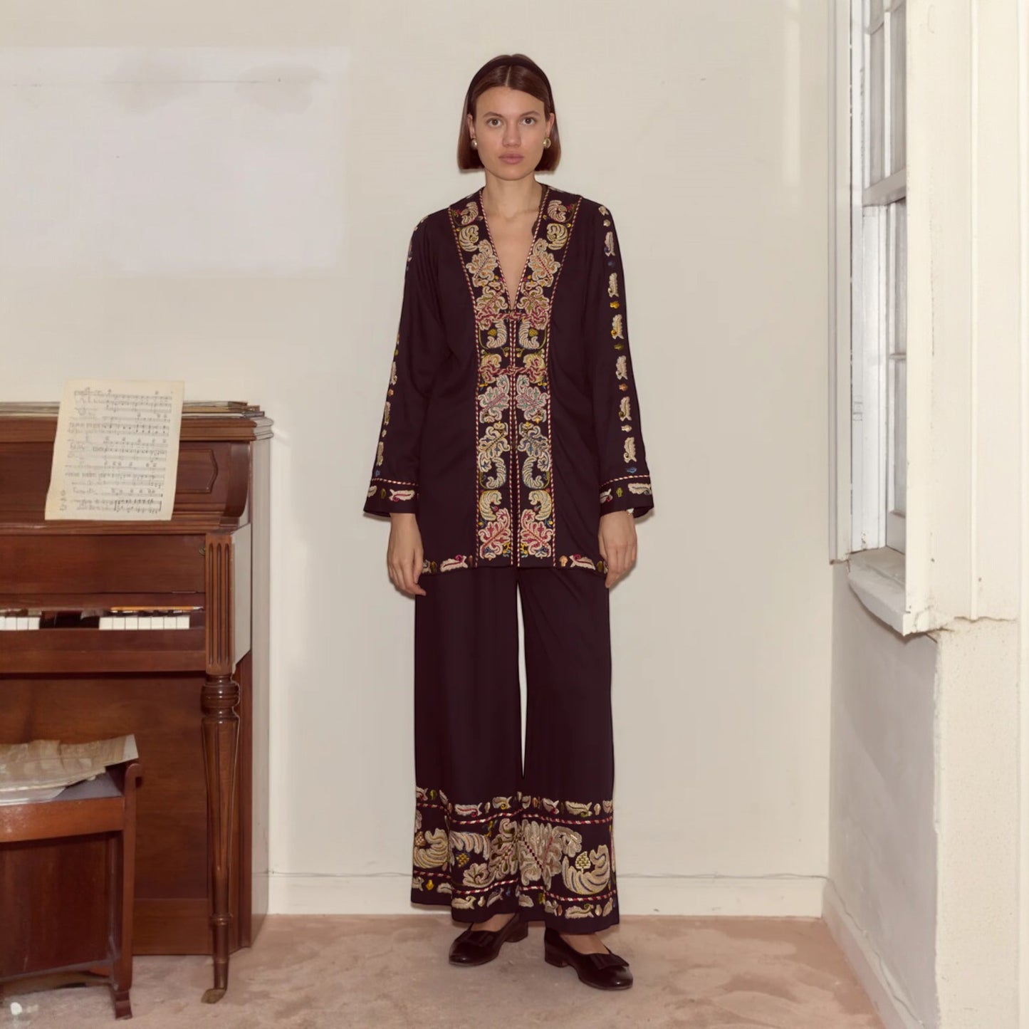 Tasoni Bode V-neck paneled runner jacket with multi-color feather embroidery and matching wide-leg pants.