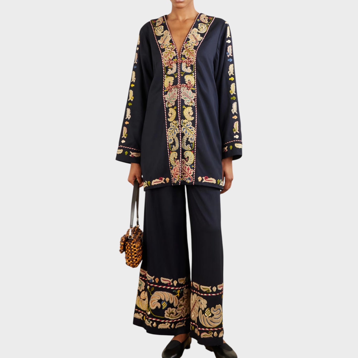 Tasoni Bode Jacket: Navy V-neck paneled runner jacket with intricate feather embroidery and matching wide-leg pants.