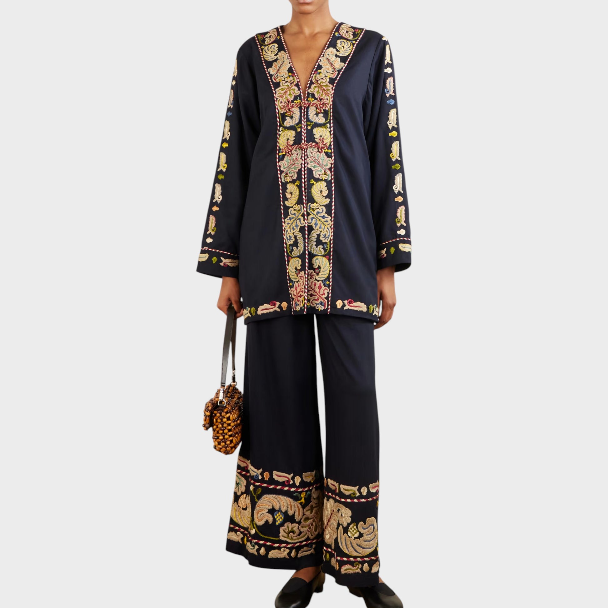 Tasoni Bode Jacket: Navy V-neck paneled runner jacket with intricate feather embroidery and matching wide-leg pants.