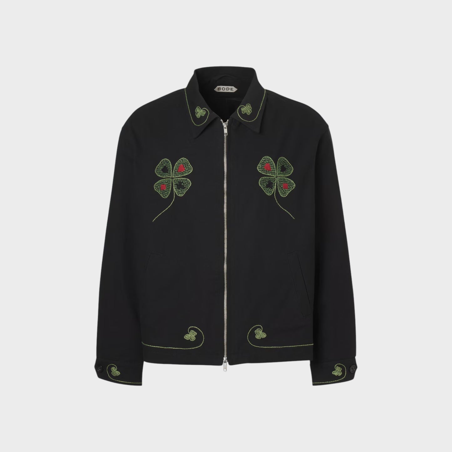 Tasoni Bode Lucky Draw embroidered black jacket with green clover and red dot details on collar, chest, and cuffs.