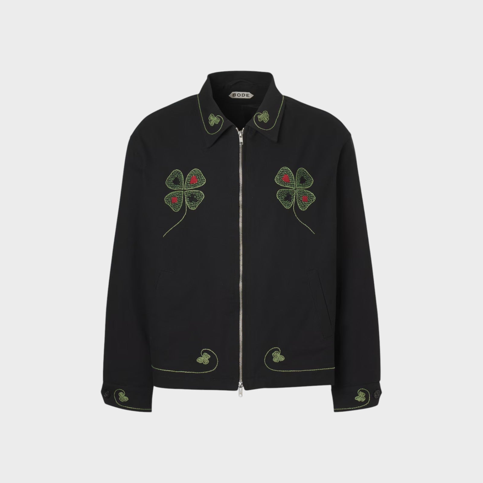 Tasoni Bode Lucky Draw embroidered black jacket with green clover and red dot details on collar, chest, and cuffs.