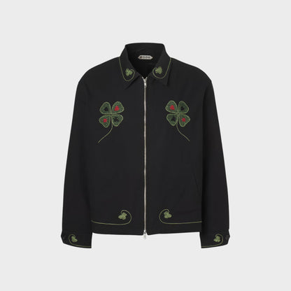 Tasoni Bode Lucky Draw embroidered black jacket with green clover and red dot details on collar, chest, and cuffs.