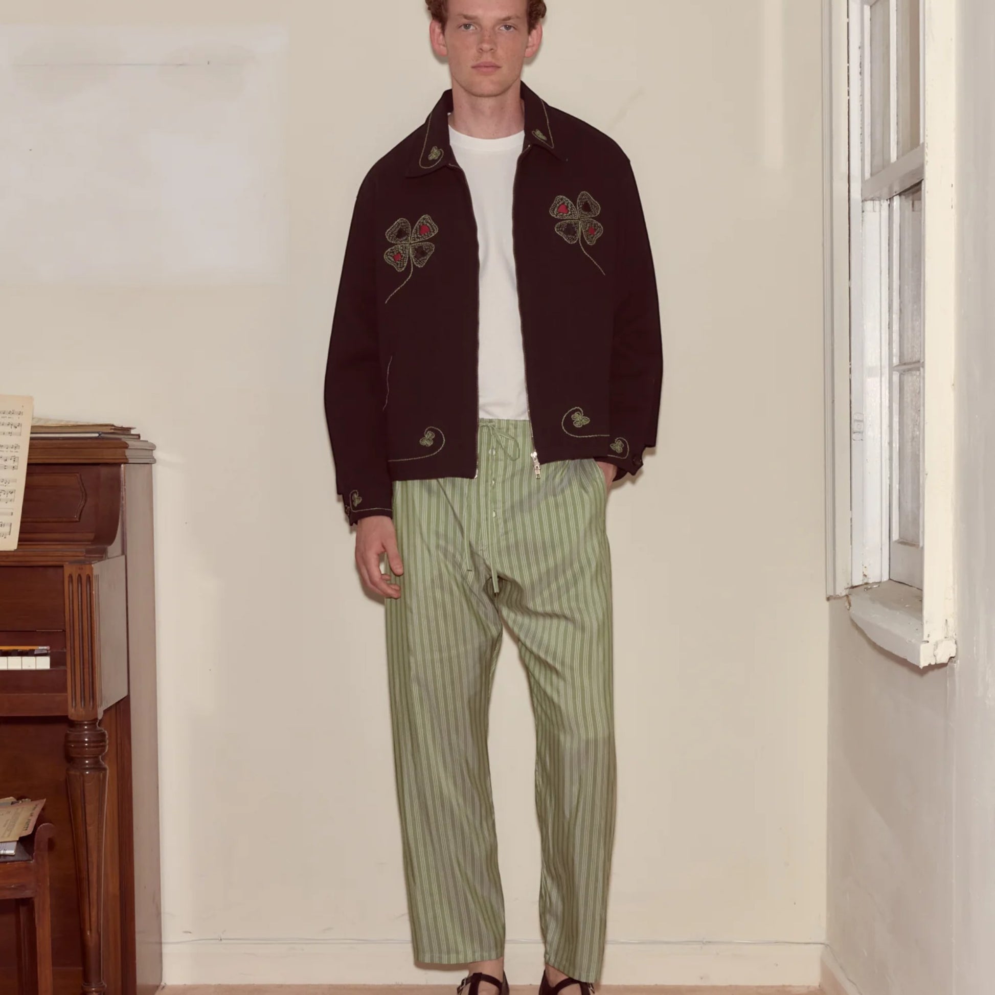 Tasoni Bode Lucky Draw Embroidered Jacket in dark brown with green and red clover embroidery. Features a zip front and classic collar.