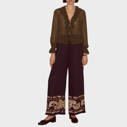 Tasoni Bode Trousers, wide leg, navy with embroidered floral hem detail. Model is wearing a green ruffled blouse.