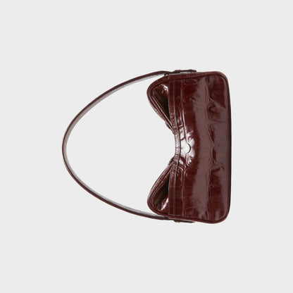 Tasoni burgundy patent leather shoulder bag with crocodile embossed finish and silver clasp.