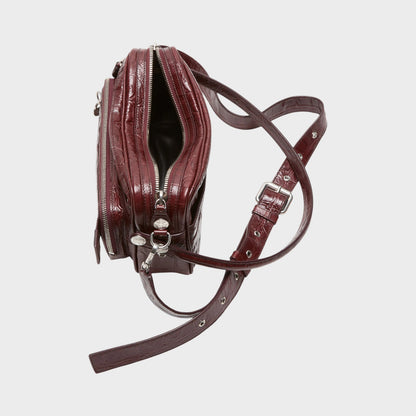 Tasoni burgundy patent leather shoulder bag with embossed crocodile texture and silver hardware.