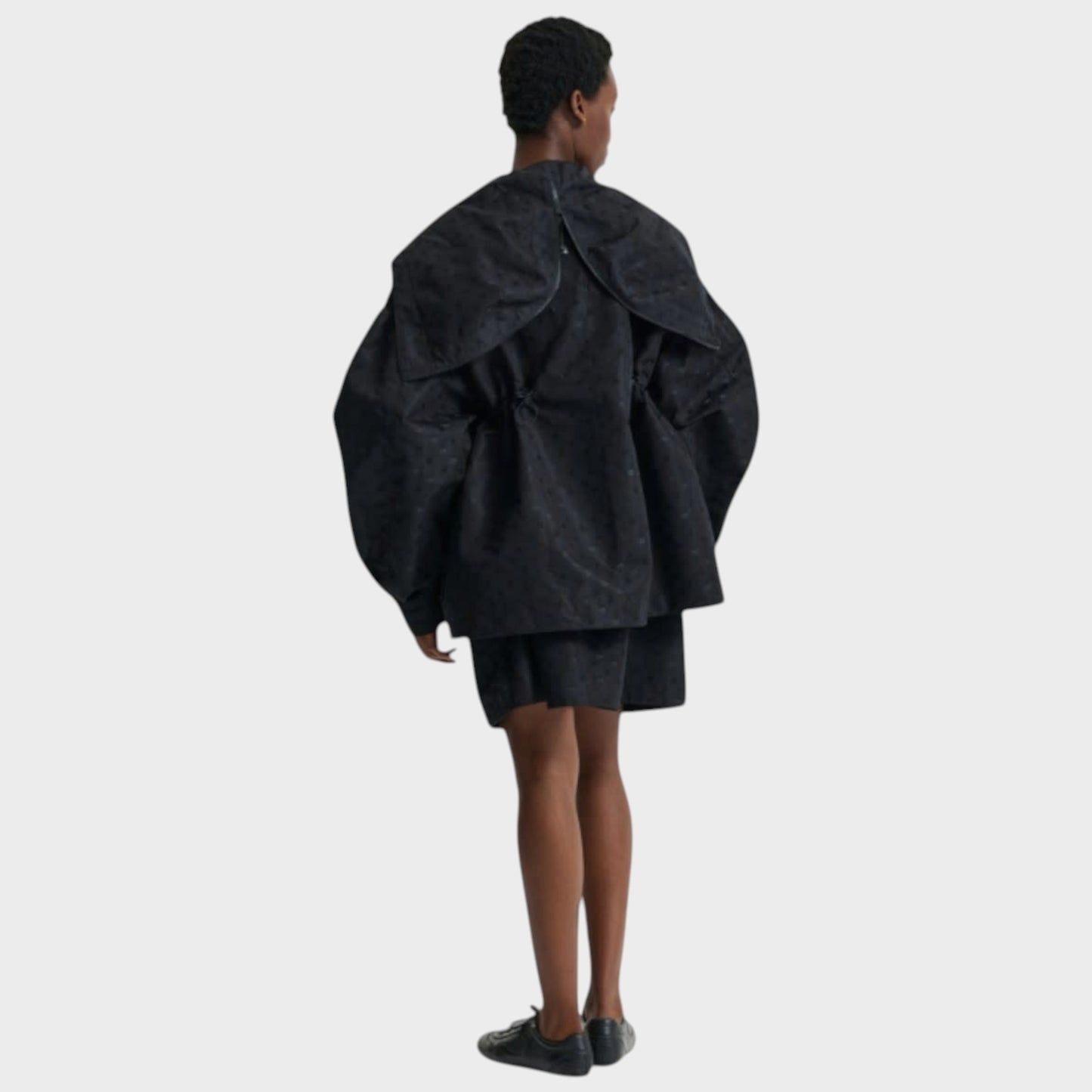 Tasoni Cecilie Bahnsen black jacquard hooded anorak jacket with drawstring waist and voluminous sleeves.