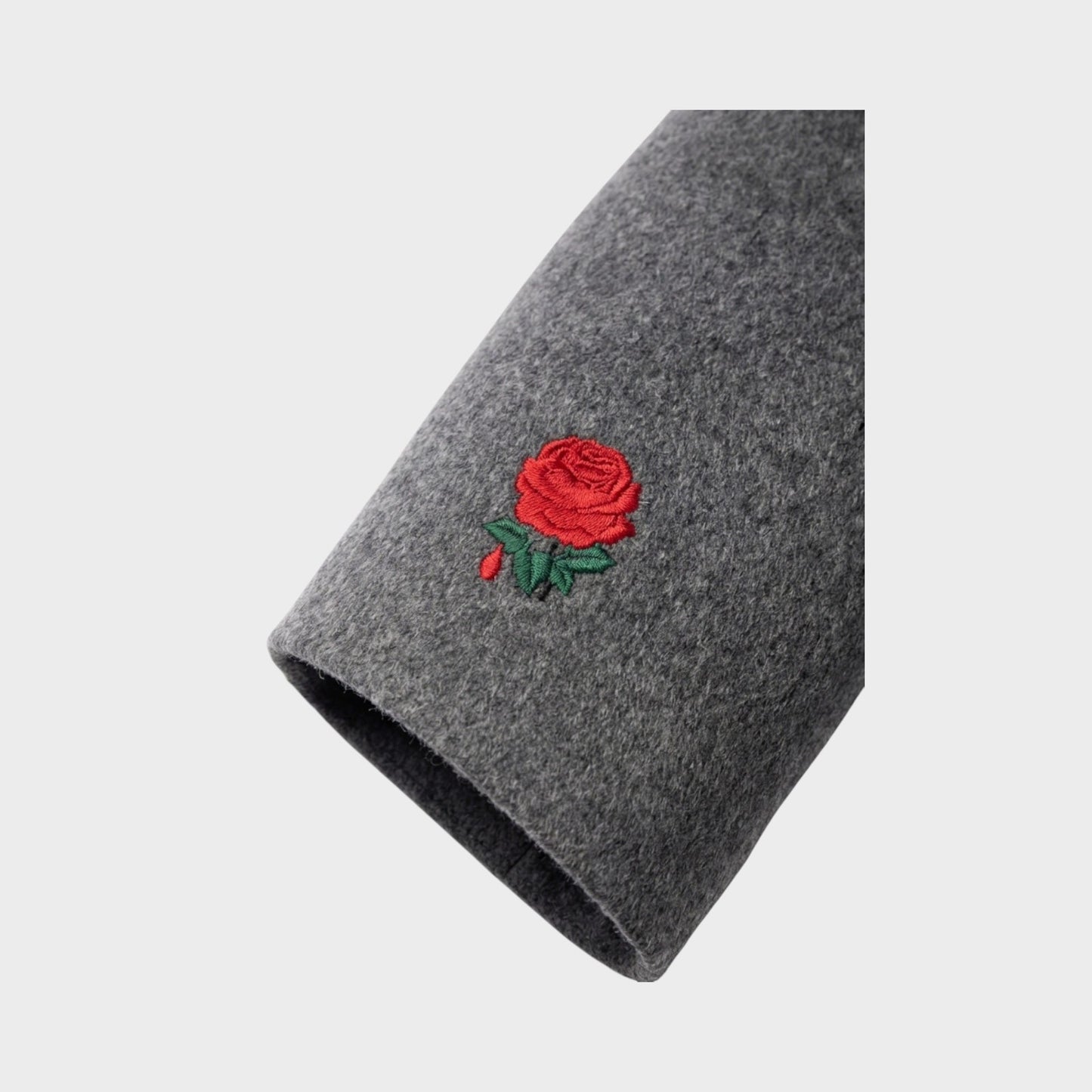 Tasoni charcoal grey wool and cashmere coat with red rose embroidery on sleeve.