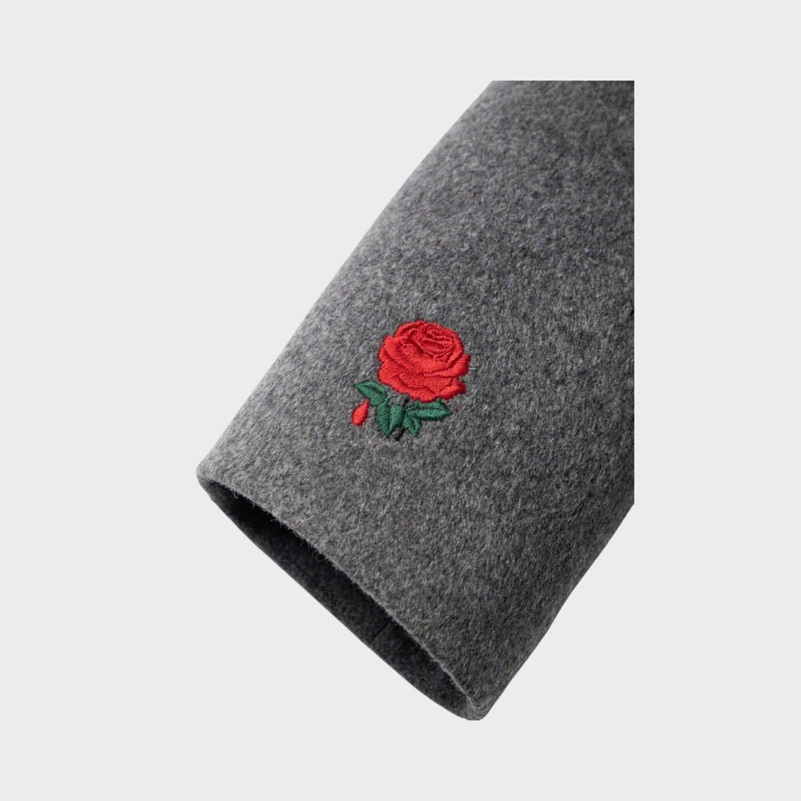 Tasoni charcoal grey wool and cashmere coat with red rose embroidery on sleeve.