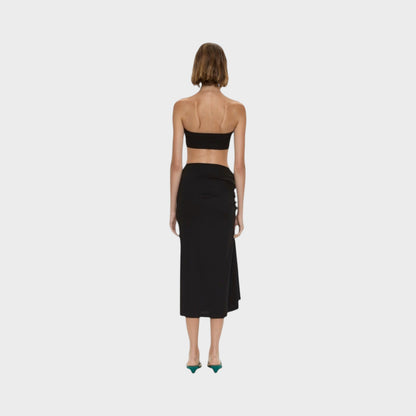 Tasoni Christopher Esber black compact ribbed midi skirt featuring a side droplet crystal clasp, back view.