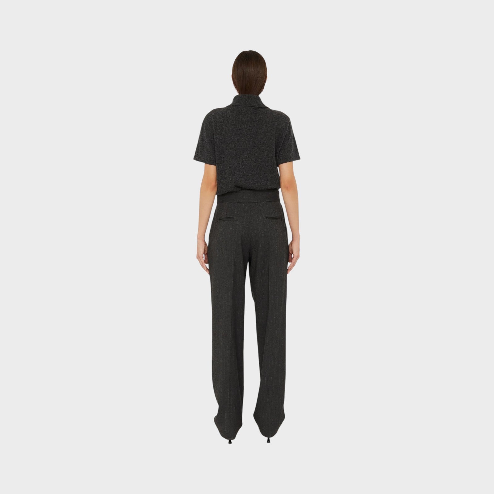 Tasoni Christopher Esber charcoal grey cashmere short sleeve polo shirt worn with pinstriped trousers, back view.