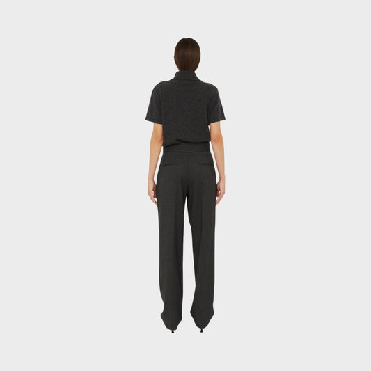 Tasoni Christopher Esber charcoal grey cashmere short sleeve polo shirt worn with pinstriped trousers, back view.