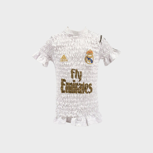 Tasoni Conner Ives white reconstituted shirred football jersey with gold logo and ruffled hem details.