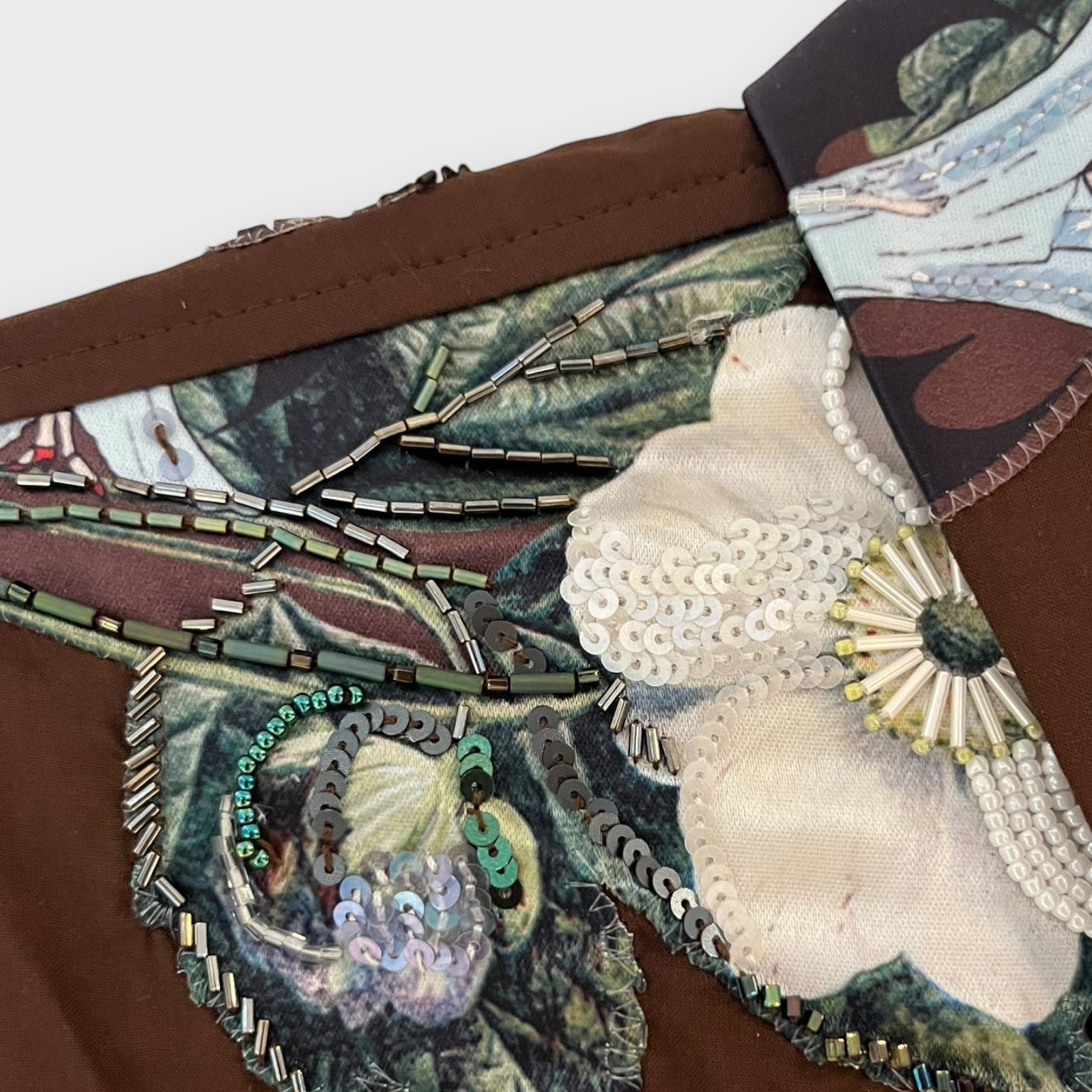 Tasoni brown shirt with intricate floral embroidery, beads, and sequins. Features a detailed collar with a botanical print.
