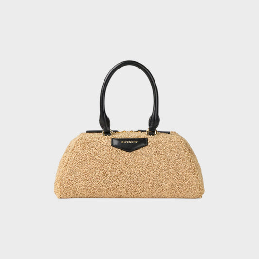 Tasoni Givenchy Antigona East West bag in beige textured material with black leather top handles and gold hardware.